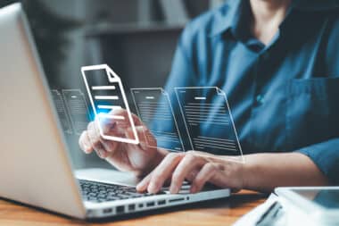 data integrity and data optimization image; woman using laptop to access healthcare payer database