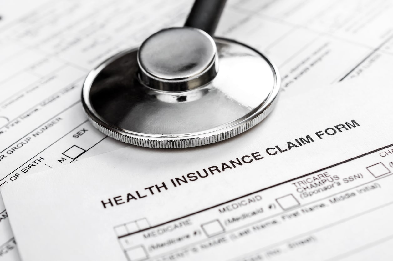 auto adjudication of healthcare claims; stethoscope on health insurance claim form